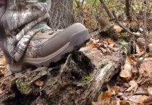 photo of the under armour brow tine 2.0 hunting boots stepping on a log
