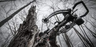 man in the woods with his top rated crossbow under 500 dollars